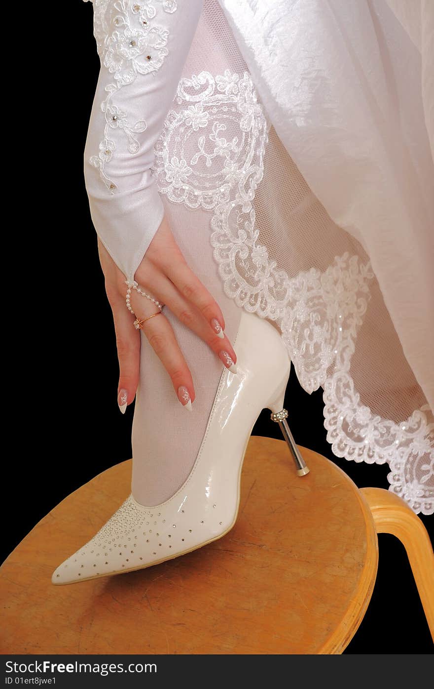 Hand and shoe of the bride.