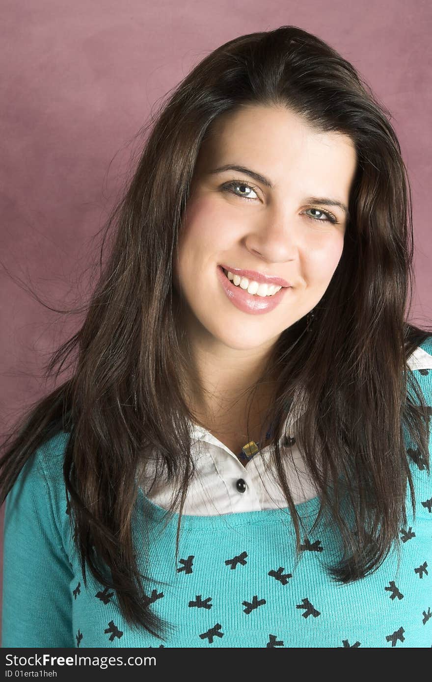 Beautiful young female wearing a blue top and jewelery