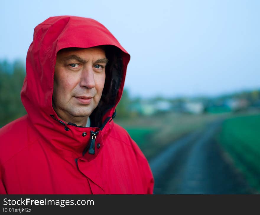 Portrait of man in red jacket outdoors - soft focus, shallow DOF. Portrait of man in red jacket outdoors - soft focus, shallow DOF