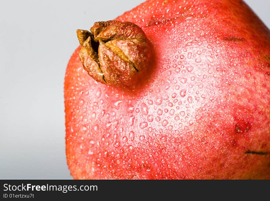 Pomegranate fruit with water drops.