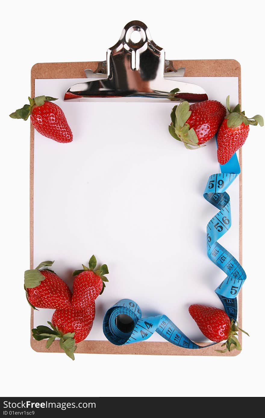 Healthy eating concept, fruit, strawberries. Tape measure and berries on clipboard