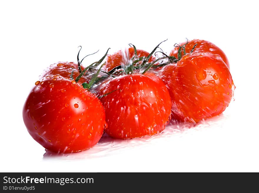 Tomatoes under pouring water