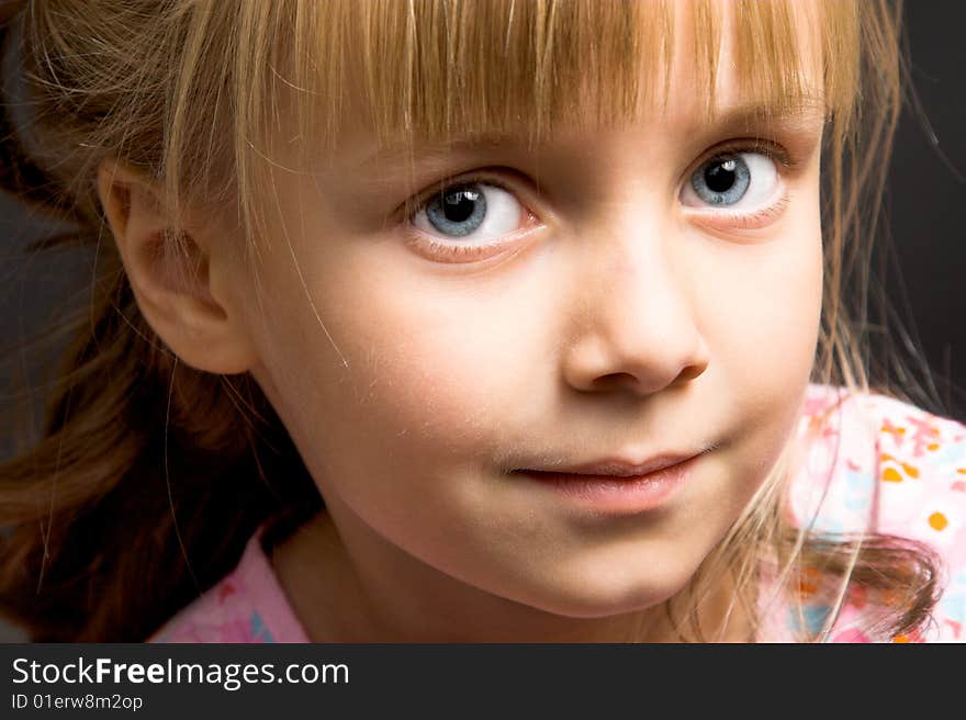 Blond Girl with big blue eyes on a black background