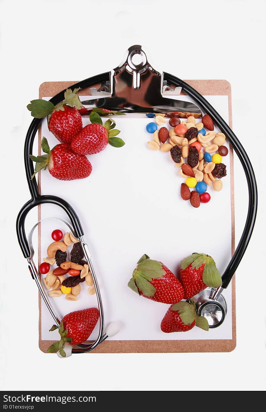 Healthy eating concept, fruits and nuts on clipboard with stethoscope