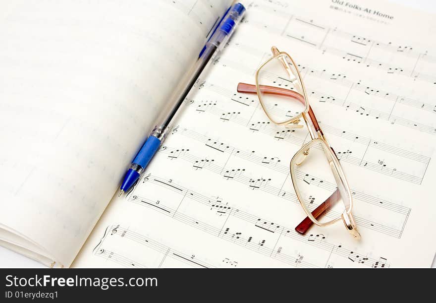 Glasses and pencil on book of notes