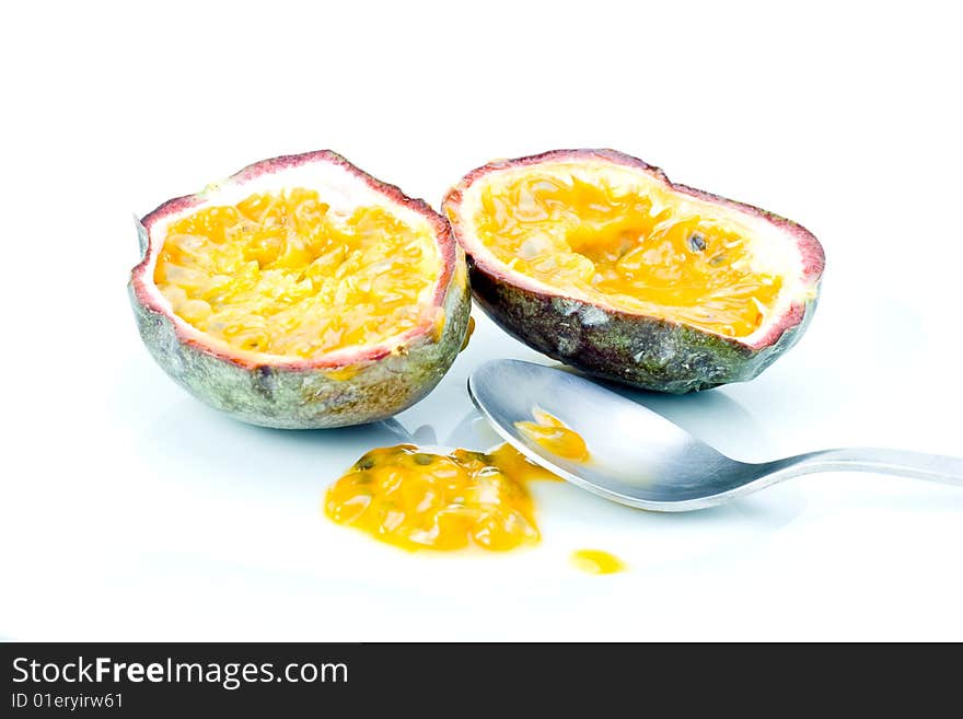 A fresh halved passion fruit with spoon