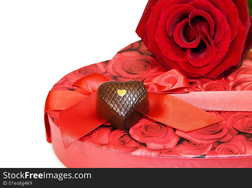 Celebrating Love - red rose and heart shaped box of chocolates isolated over white. Clipping path included at original size. Celebrating Love - red rose and heart shaped box of chocolates isolated over white. Clipping path included at original size.