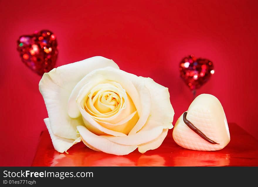 Passionate love - white rose and sparkling hearts over red background. Passionate love - white rose and sparkling hearts over red background.