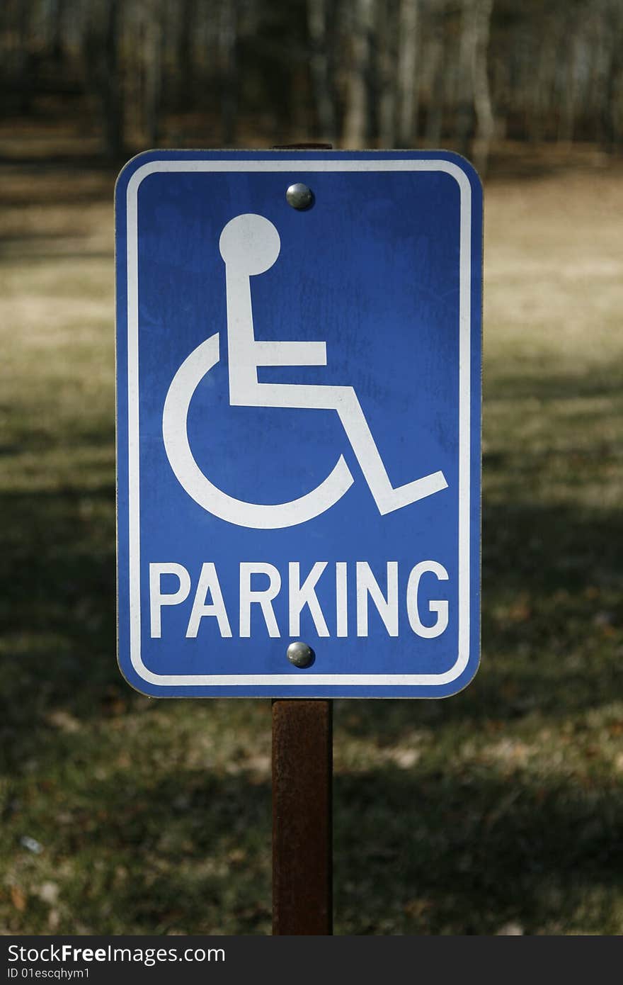 A sign showing a reserved parking space for individuals with a handicap. A sign showing a reserved parking space for individuals with a handicap.