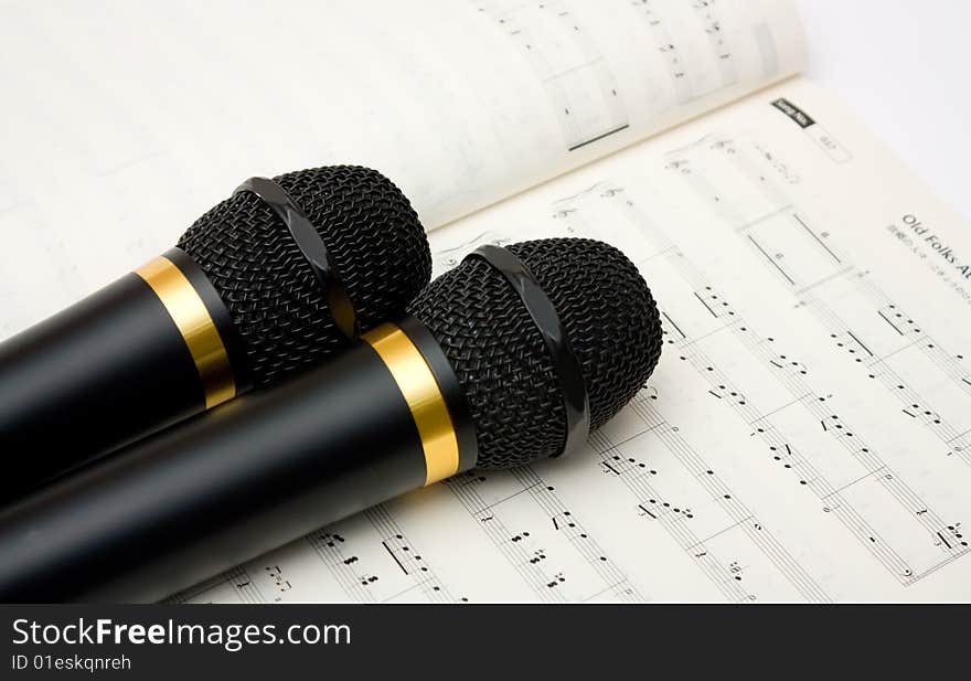 Closeup image of microphone and book of notes