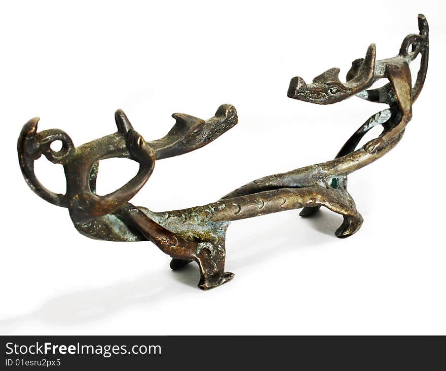 Old figurine made of bronze in the form of two dragons