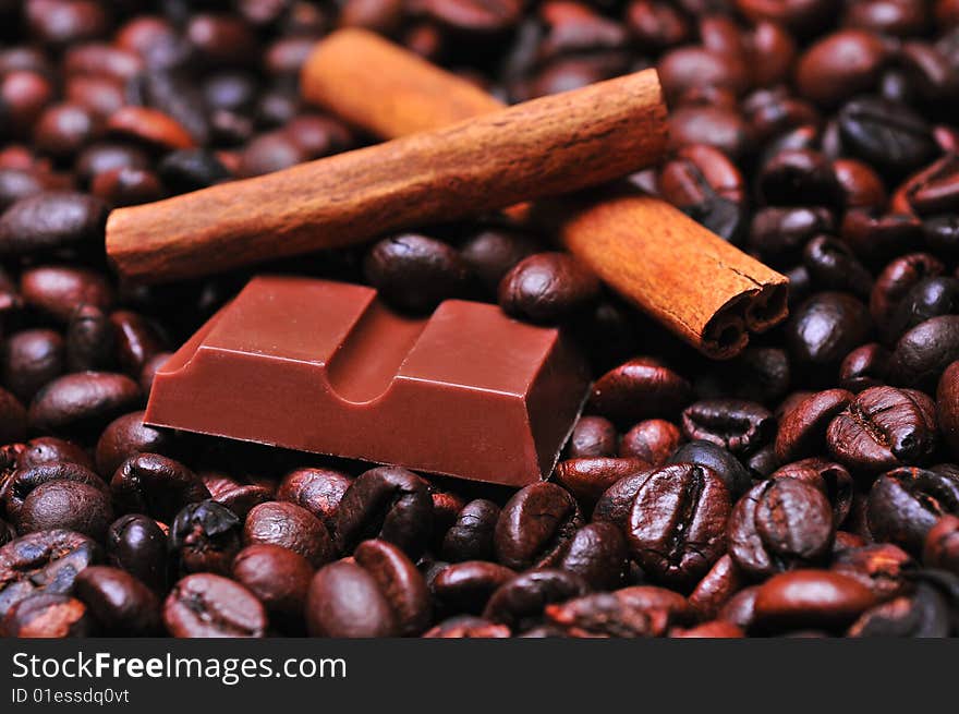 Close up of a coffee beans and chocolate with cinnamon. Close up of a coffee beans and chocolate with cinnamon