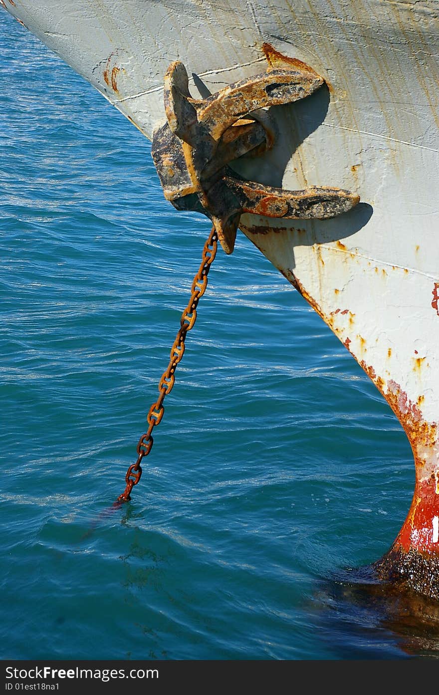 Rusty anchor and chain at the seaport