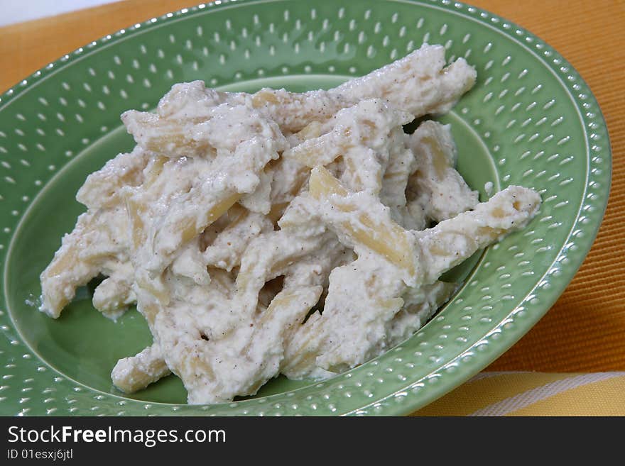 Macaroni in white cream sauce  on plate