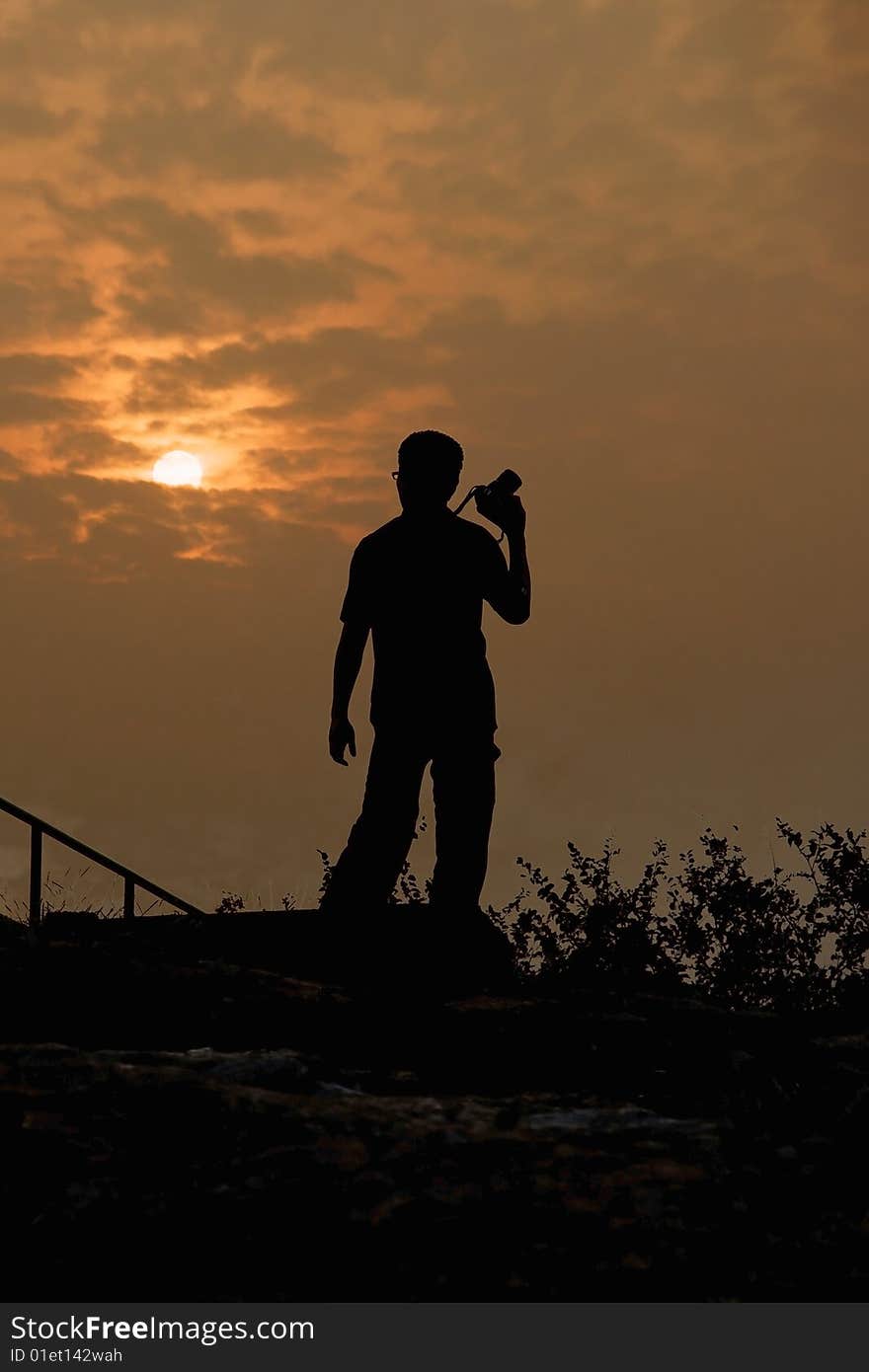 Photographer facing sunset