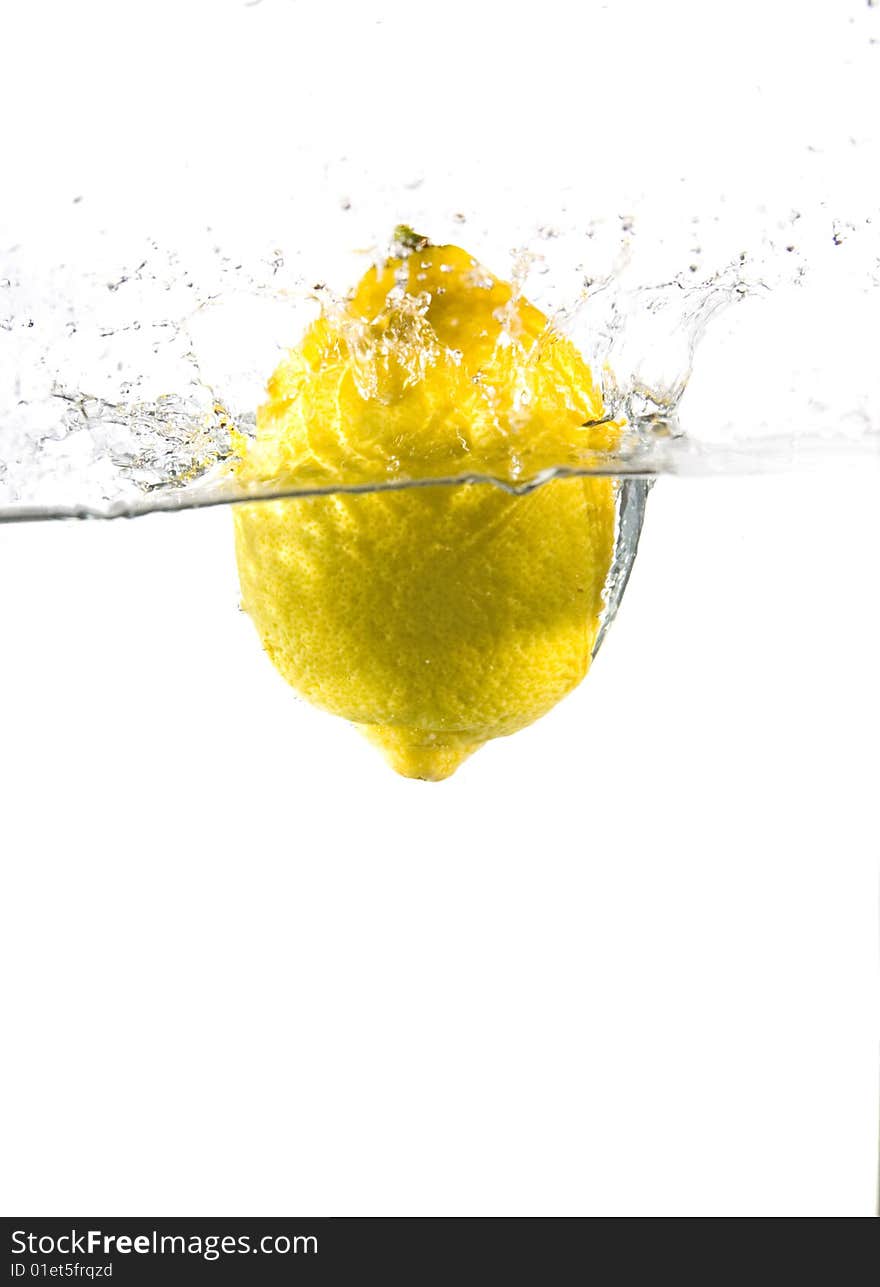 Lemon in water with bubbles on white ground