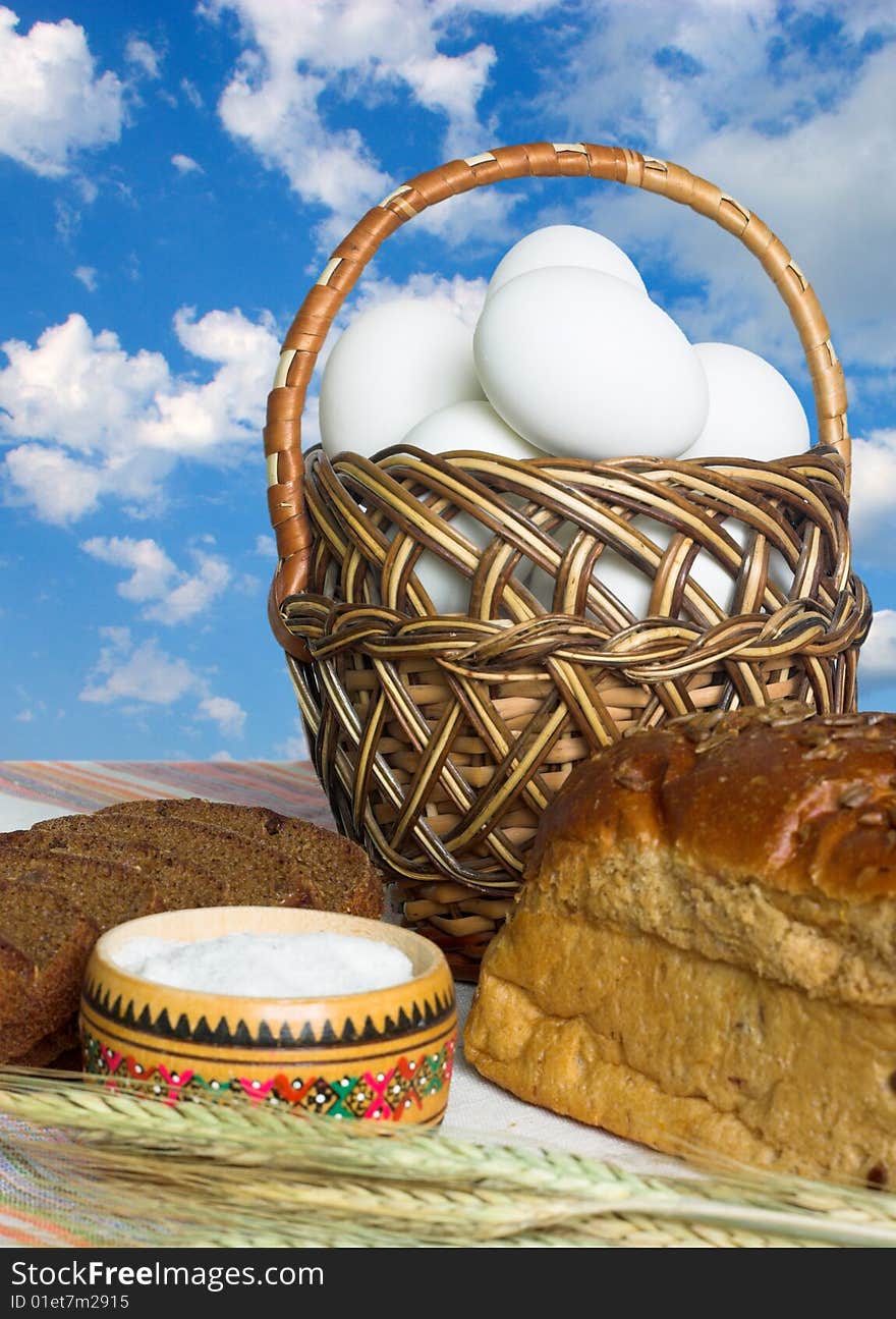 Easter food -eggs, bread and salt on sky background. Easter food -eggs, bread and salt on sky background