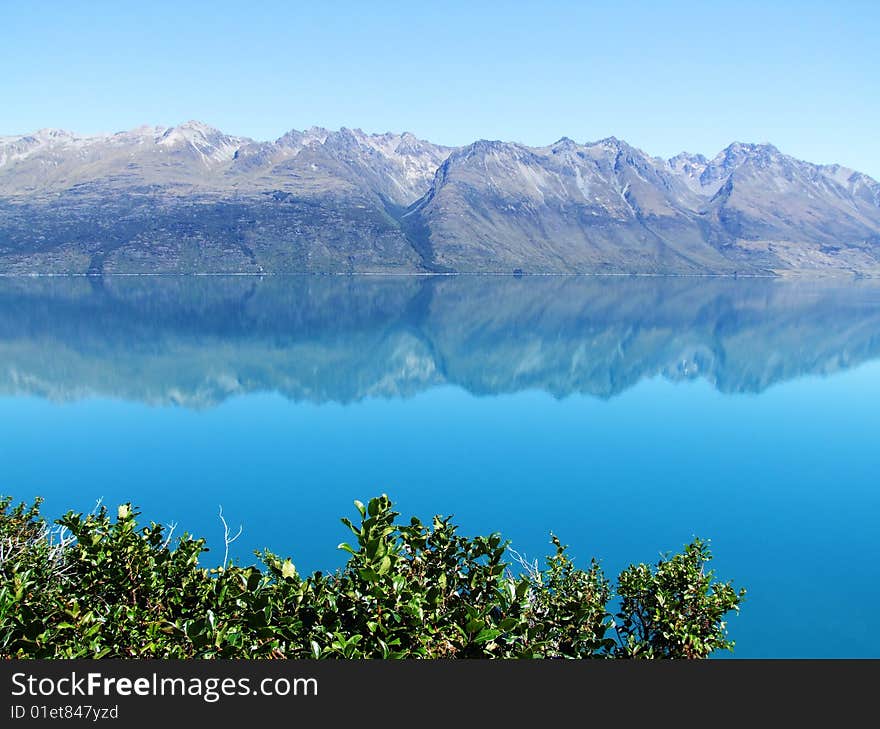 Scenic photo of a Lake with mountains in the background somewhere in New Zealand