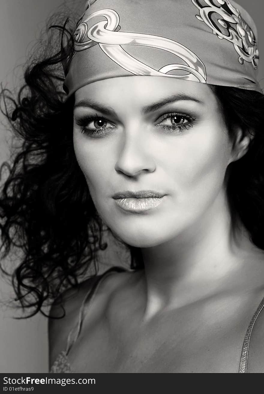 Portrait of the girl with a scarf on a head. B&W photo. Portrait of the girl with a scarf on a head. B&W photo.