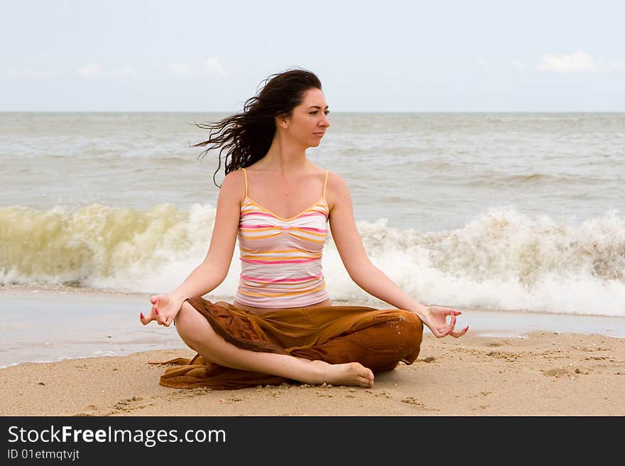 Girl meditation in the beach