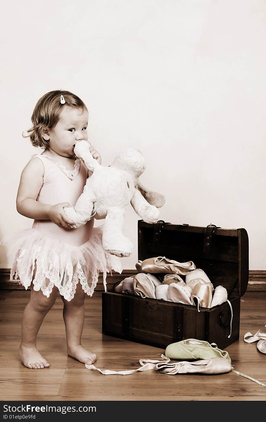 Little girl with short hair wearing a pink ballet outfit