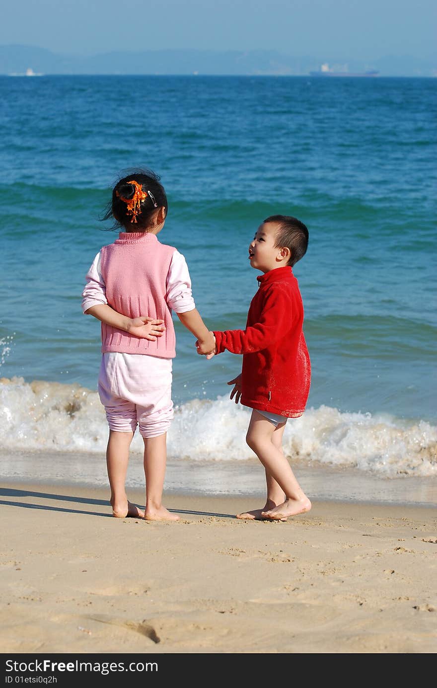 Young Kids Playing in the surfy beach