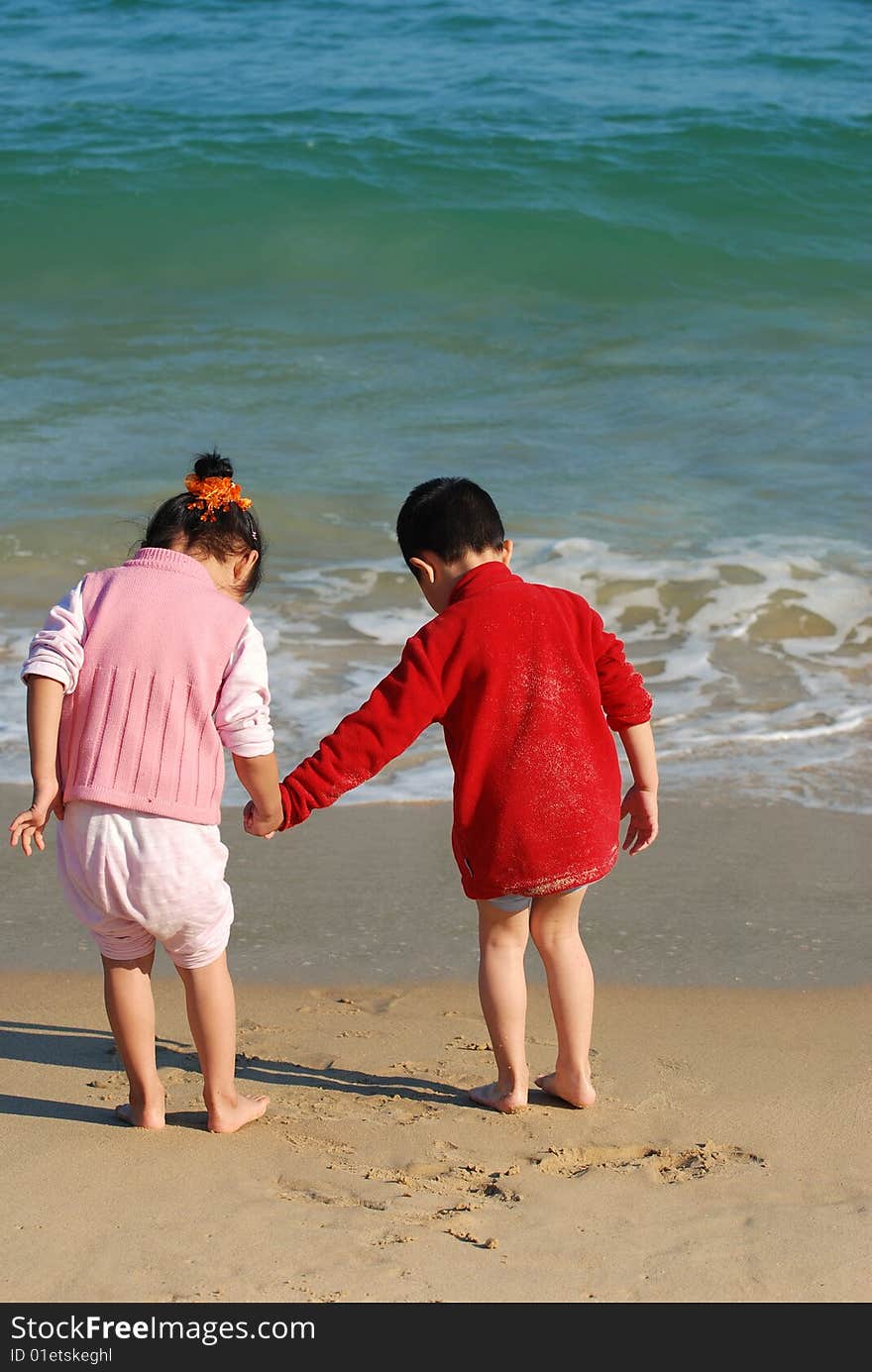 Young Kids Playing in the surfy beach