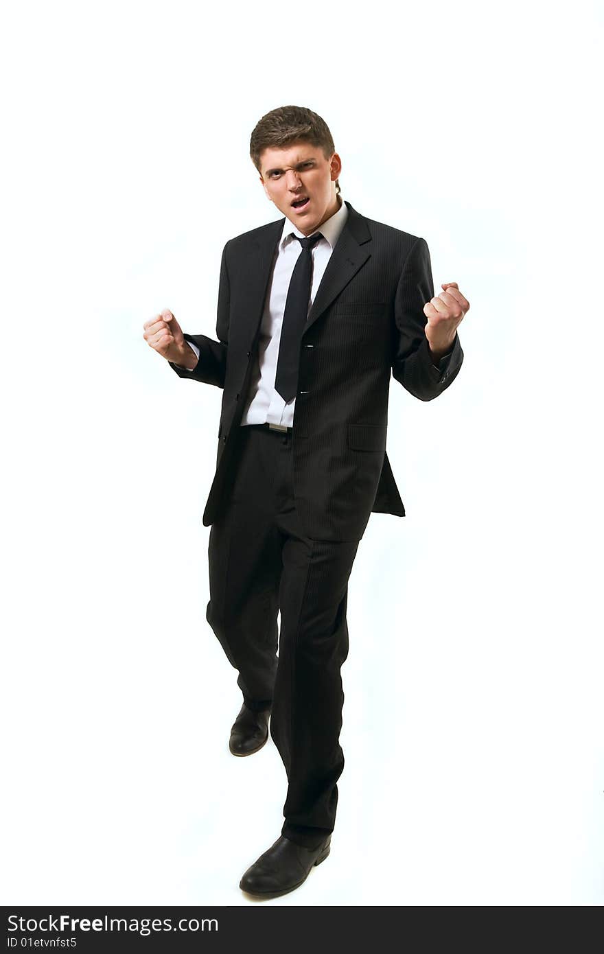 Young successfull businessman with his arms raised on white background.