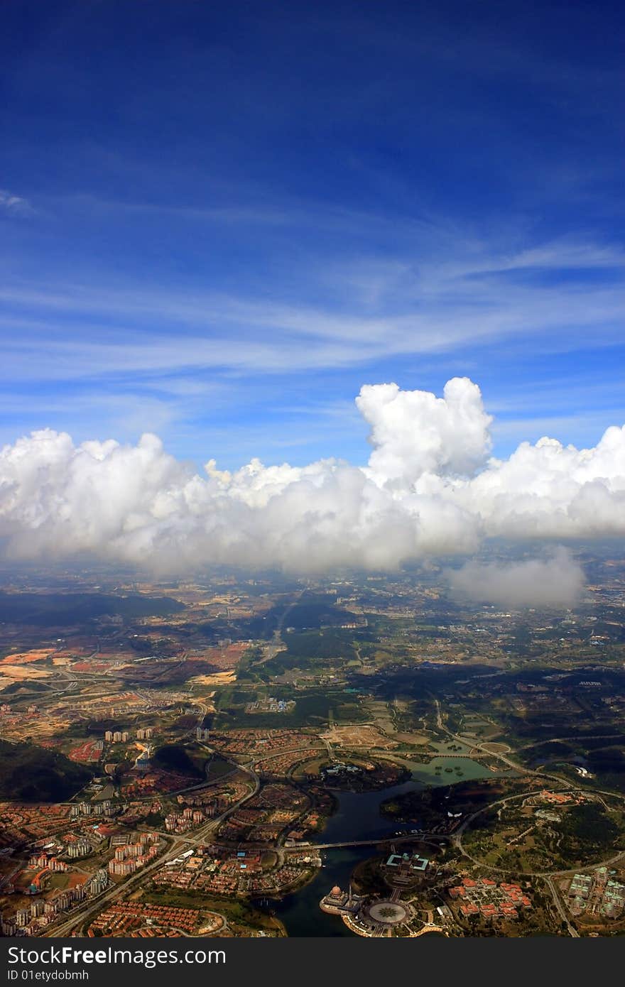 Aerial view of cloudscape over a cityscape.