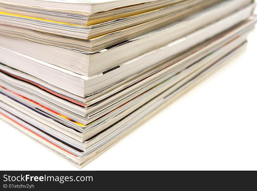 Stack of magazines on white background