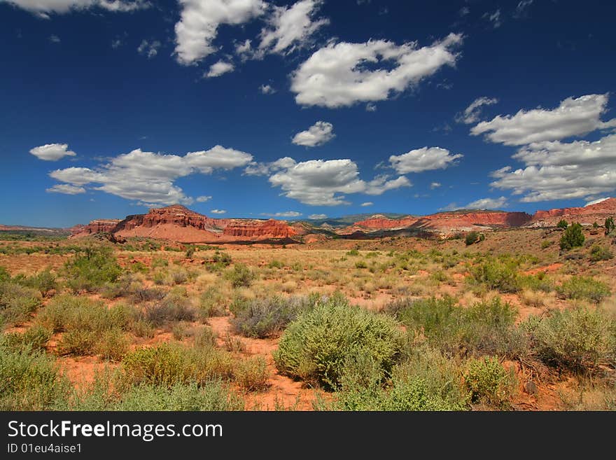 View of the red rock formations in Capitol Reef National Park with blue sky�s and clouds. View of the red rock formations in Capitol Reef National Park with blue sky�s and clouds