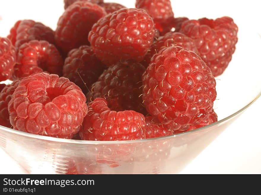 A cocktail glass of raspberries. A cocktail glass of raspberries