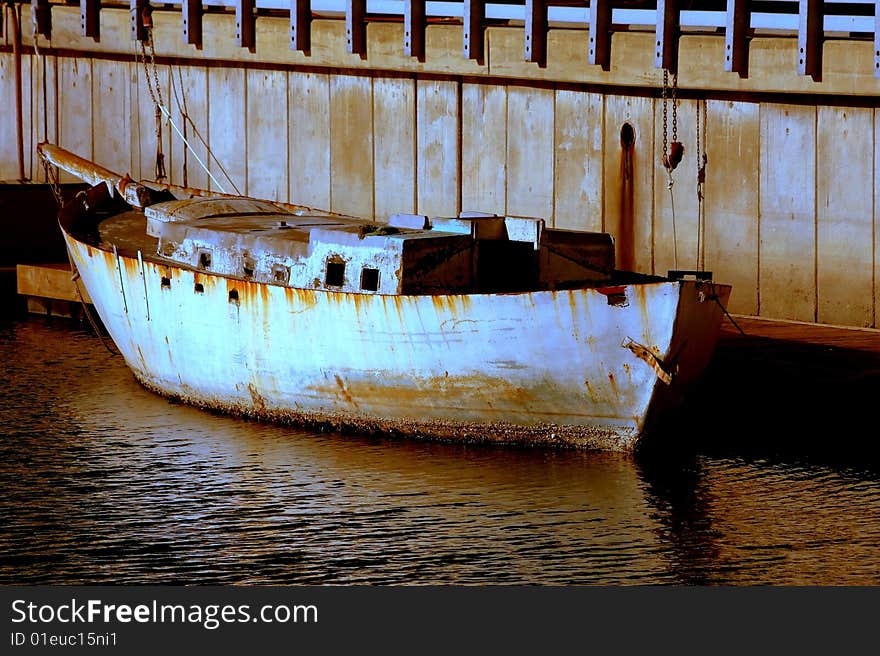 Old cement boat docked at half moon bay harbor.