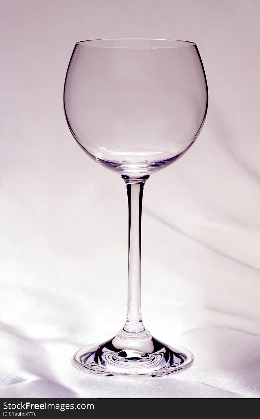 Empty glass of wine on a white cloth