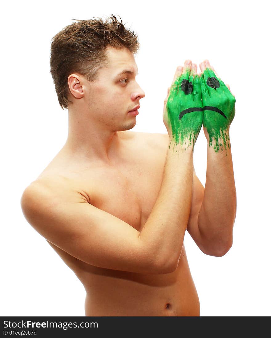 Picture of sad young man looking at sad smile mask painted on his hands isolated on white background