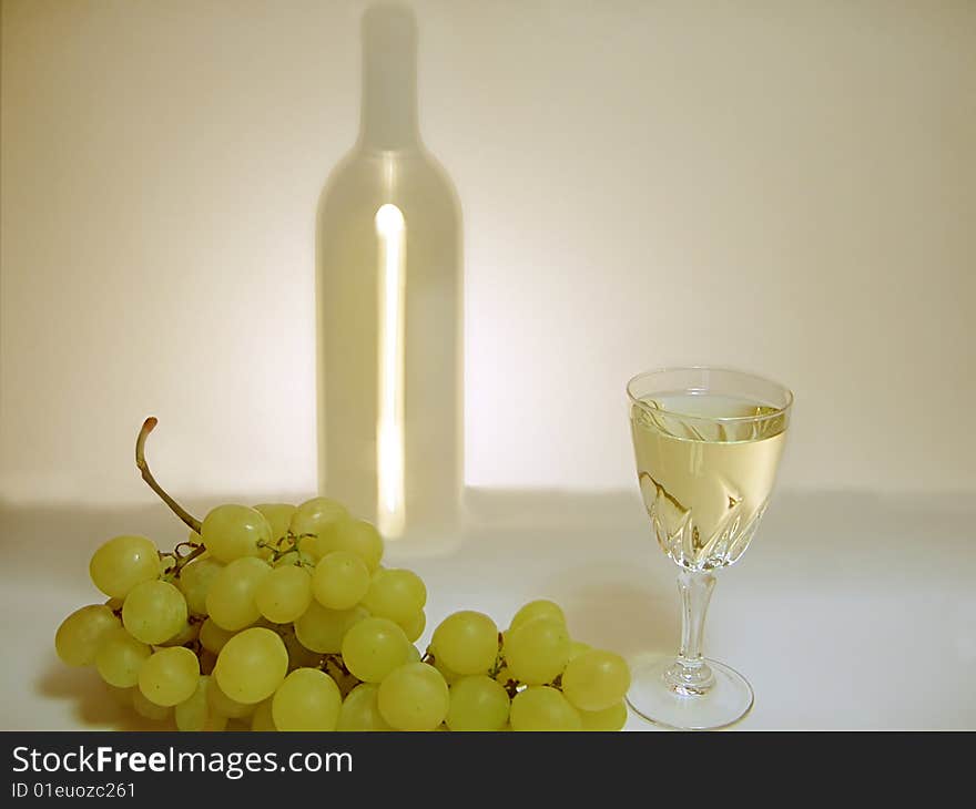 Wineglass, bunch of grapes and silhouette of bottle with white wine. Wineglass, bunch of grapes and silhouette of bottle with white wine.