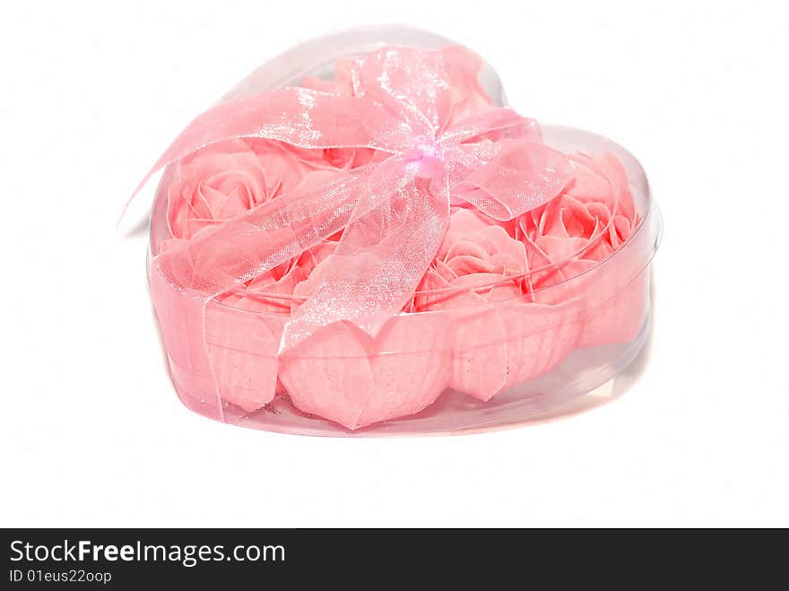 Pink little roses are in the plastic heart box. Pink little roses are in the plastic heart box.