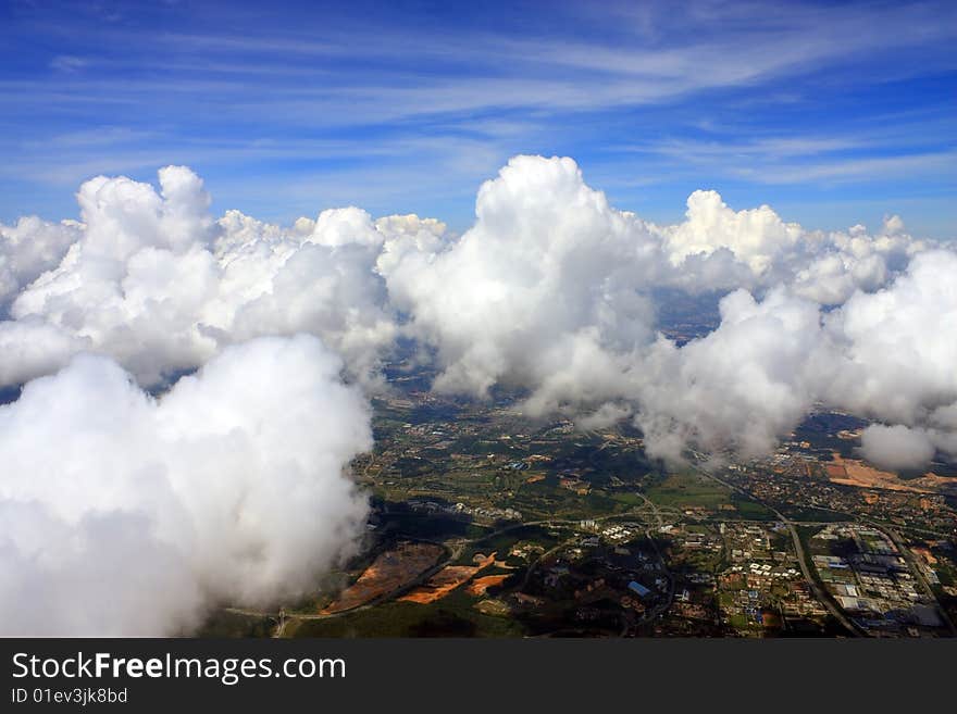 Aerial view of cloudscape over a cityscape.