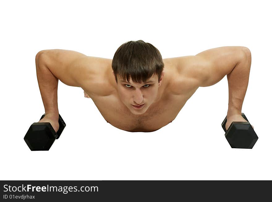 The young man does exercise with dumbbell. The young man does exercise with dumbbell