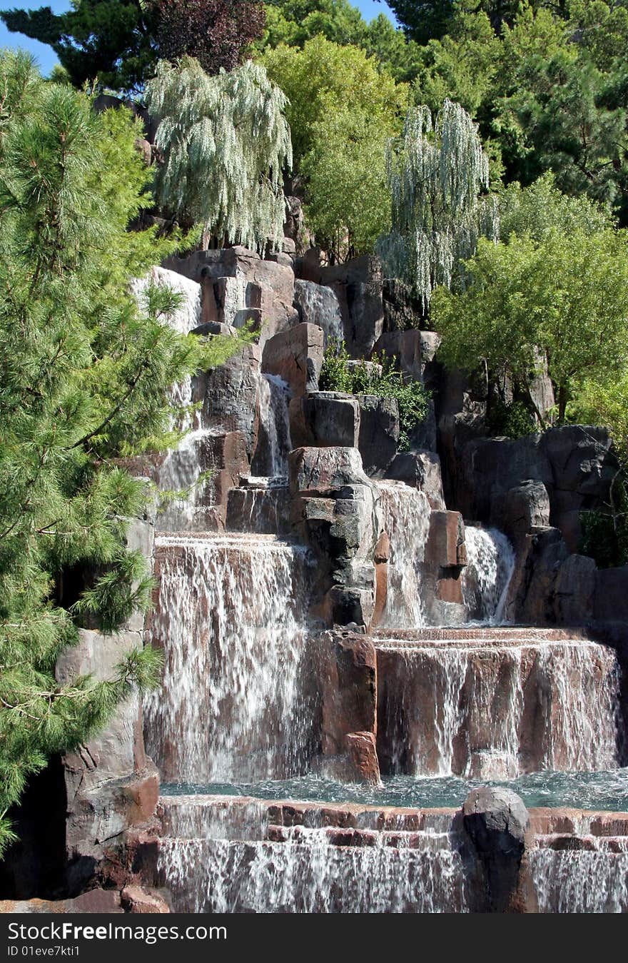 A lush waterfall in the middle of green pine trees