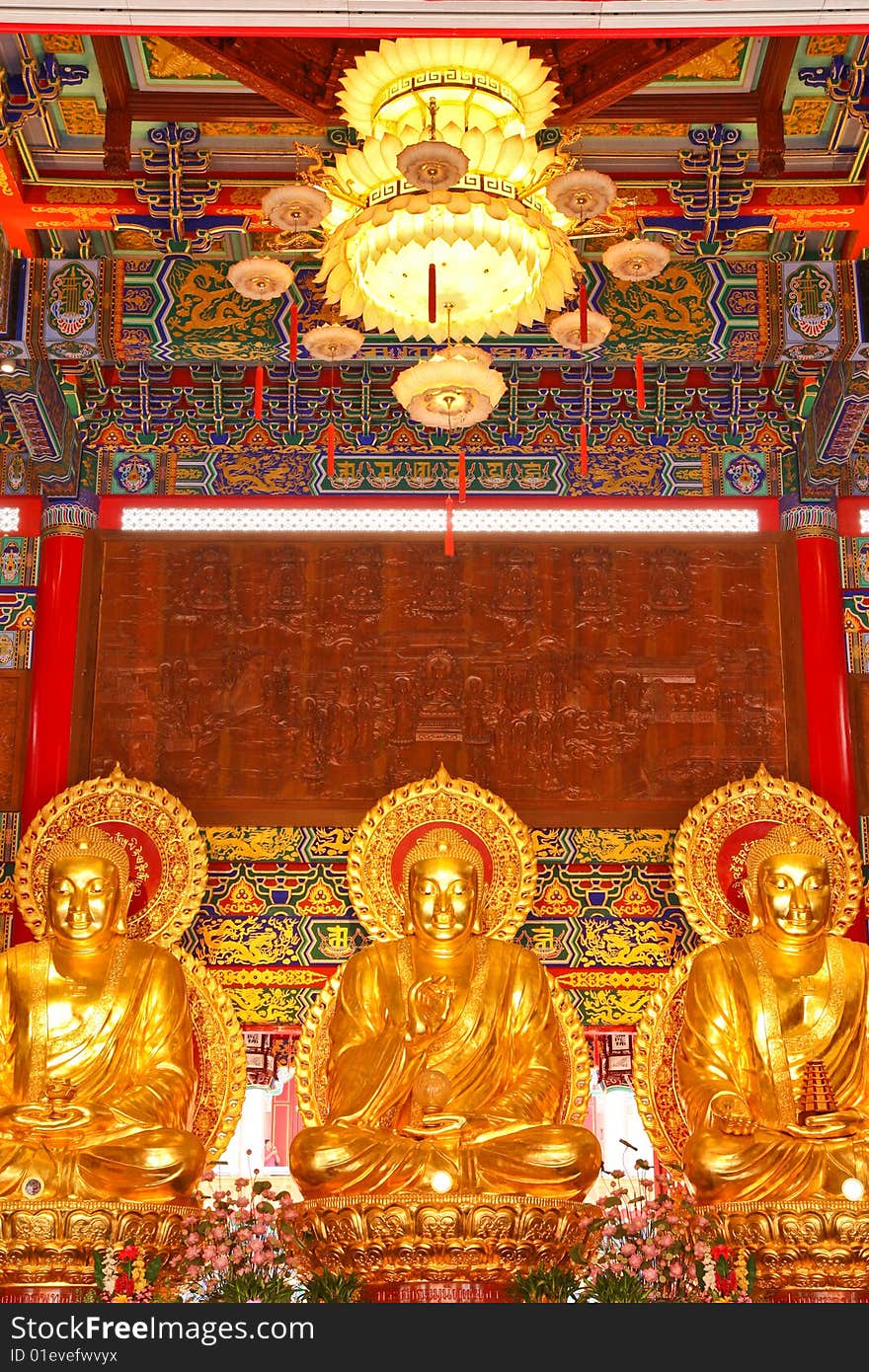 Three Golden Buddha images in main pavilion of Chinese temple, Nonthaburi, Thailand. Three Golden Buddha images in main pavilion of Chinese temple, Nonthaburi, Thailand