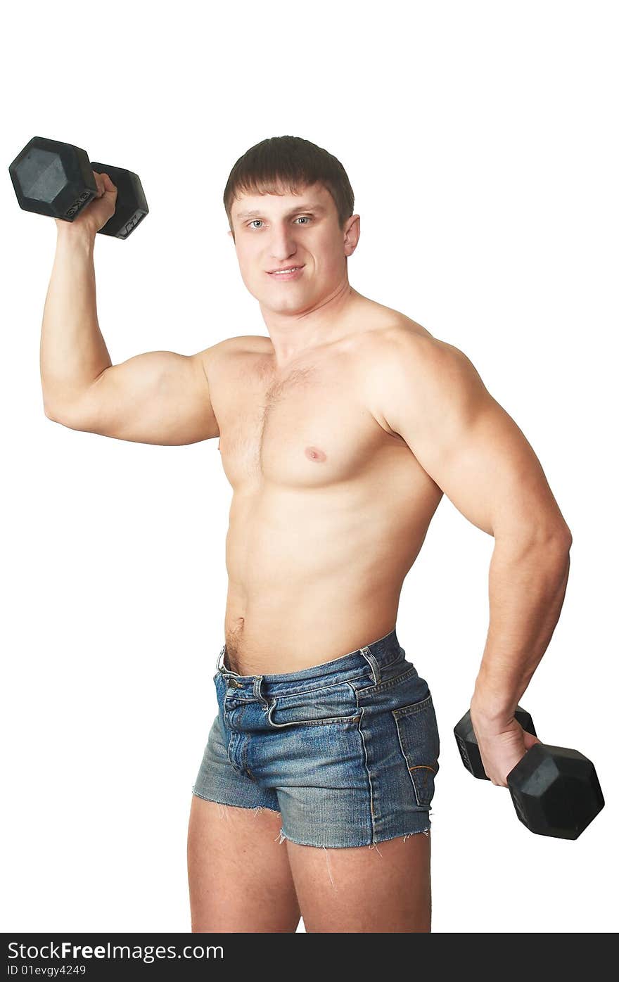 The man does(makes) gymnastic exercises with dumbbell. The man does(makes) gymnastic exercises with dumbbell