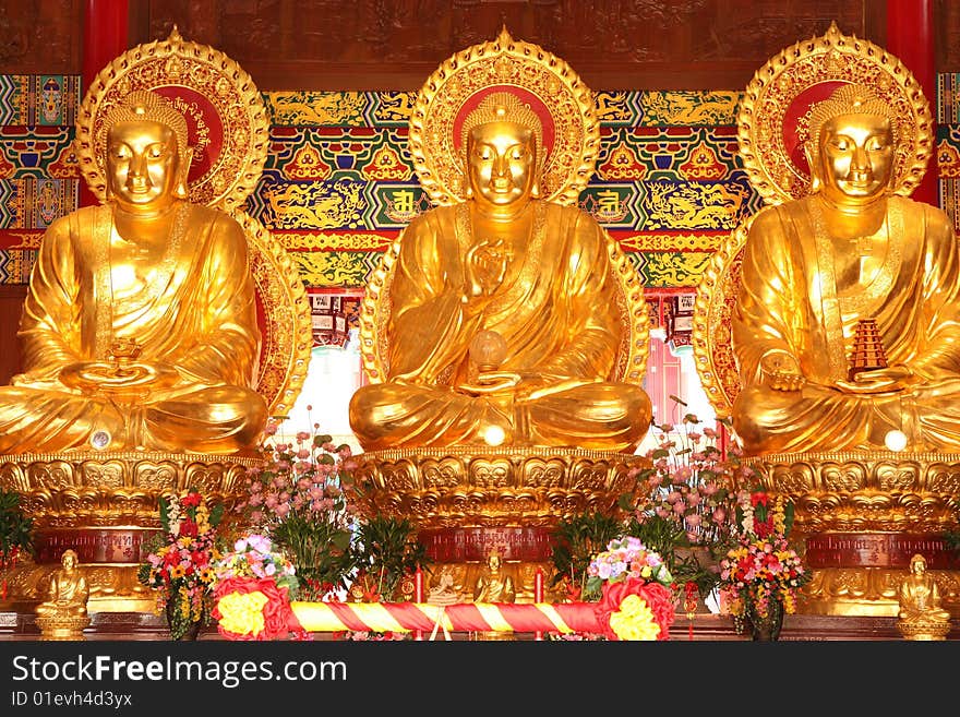 Three Golden Buddha images in main pavilion of Chinese temple, Nonthaburi, Thailand. Three Golden Buddha images in main pavilion of Chinese temple, Nonthaburi, Thailand