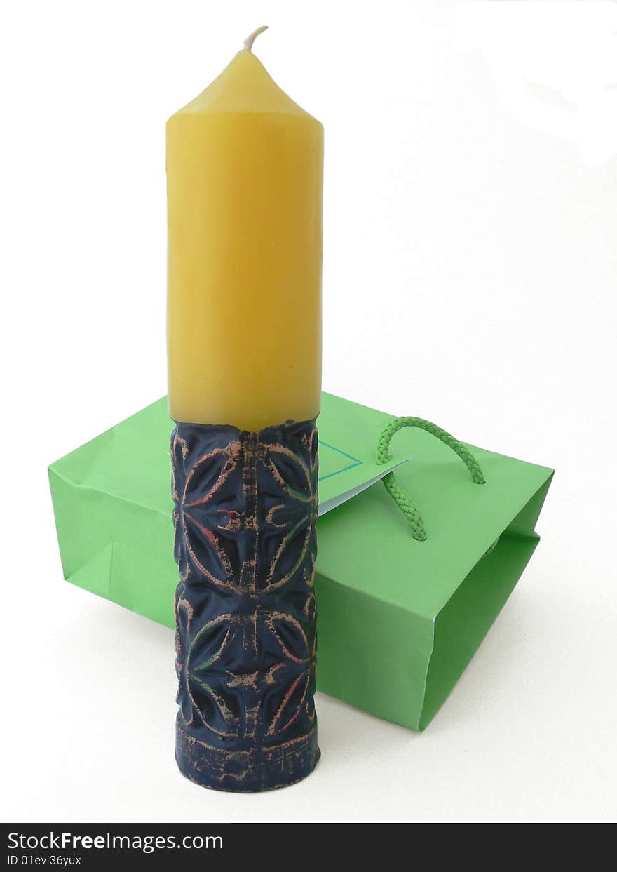 It \' s an art candle with green packet over white background