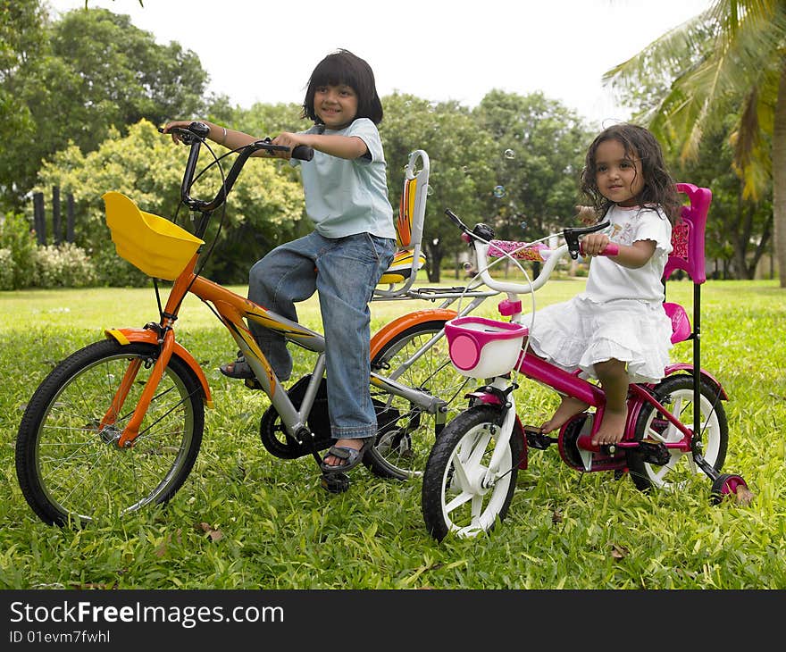 Asian girl in the garden riding her cycle