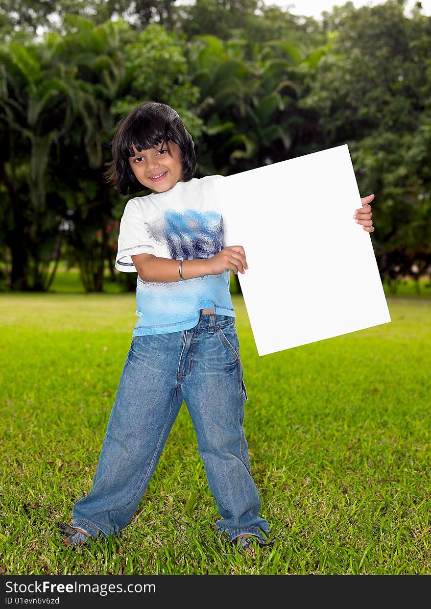 Girl with a blank placard in the garden