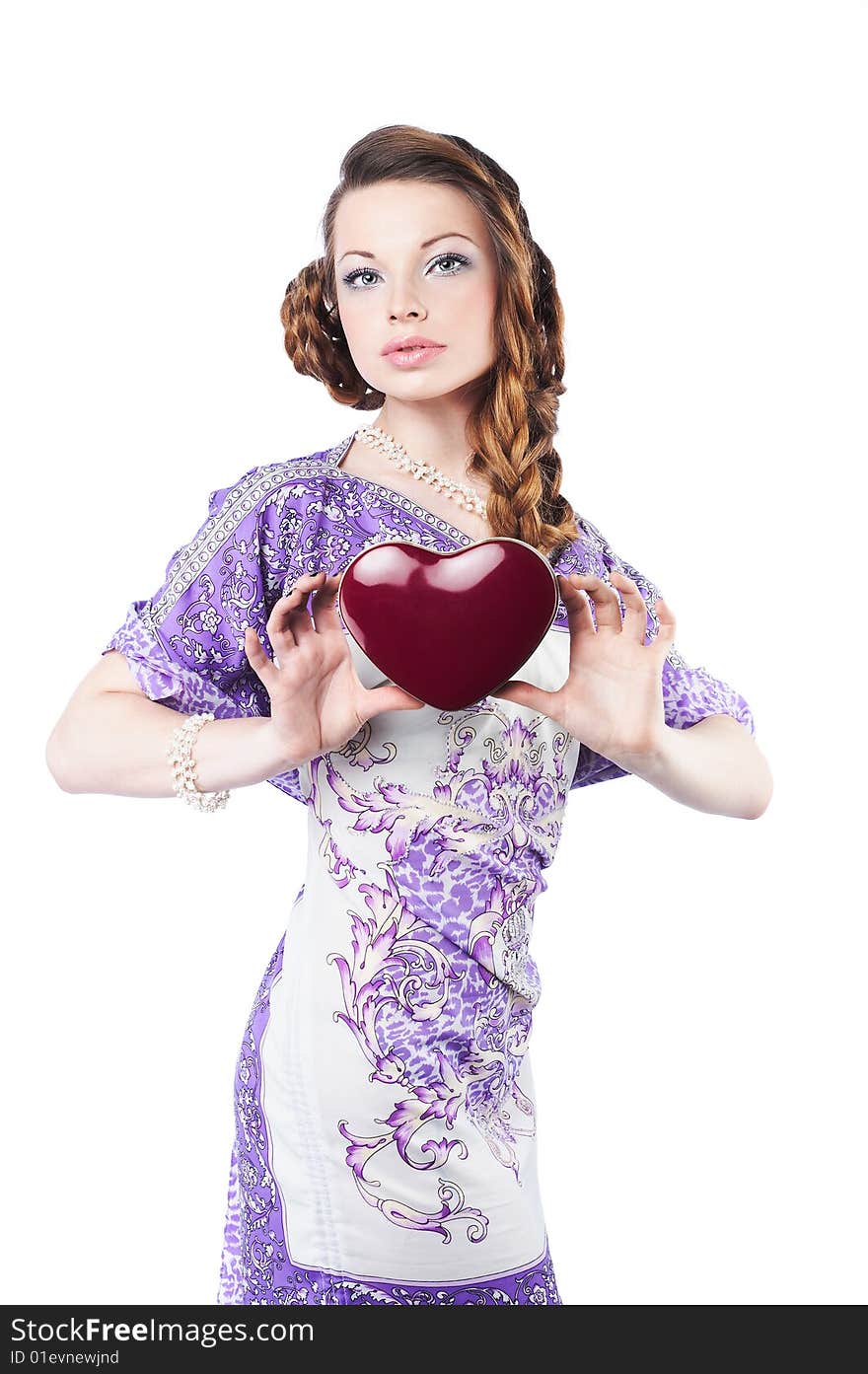 Beautiful romantic woman holding a dark red heart, isolated on white