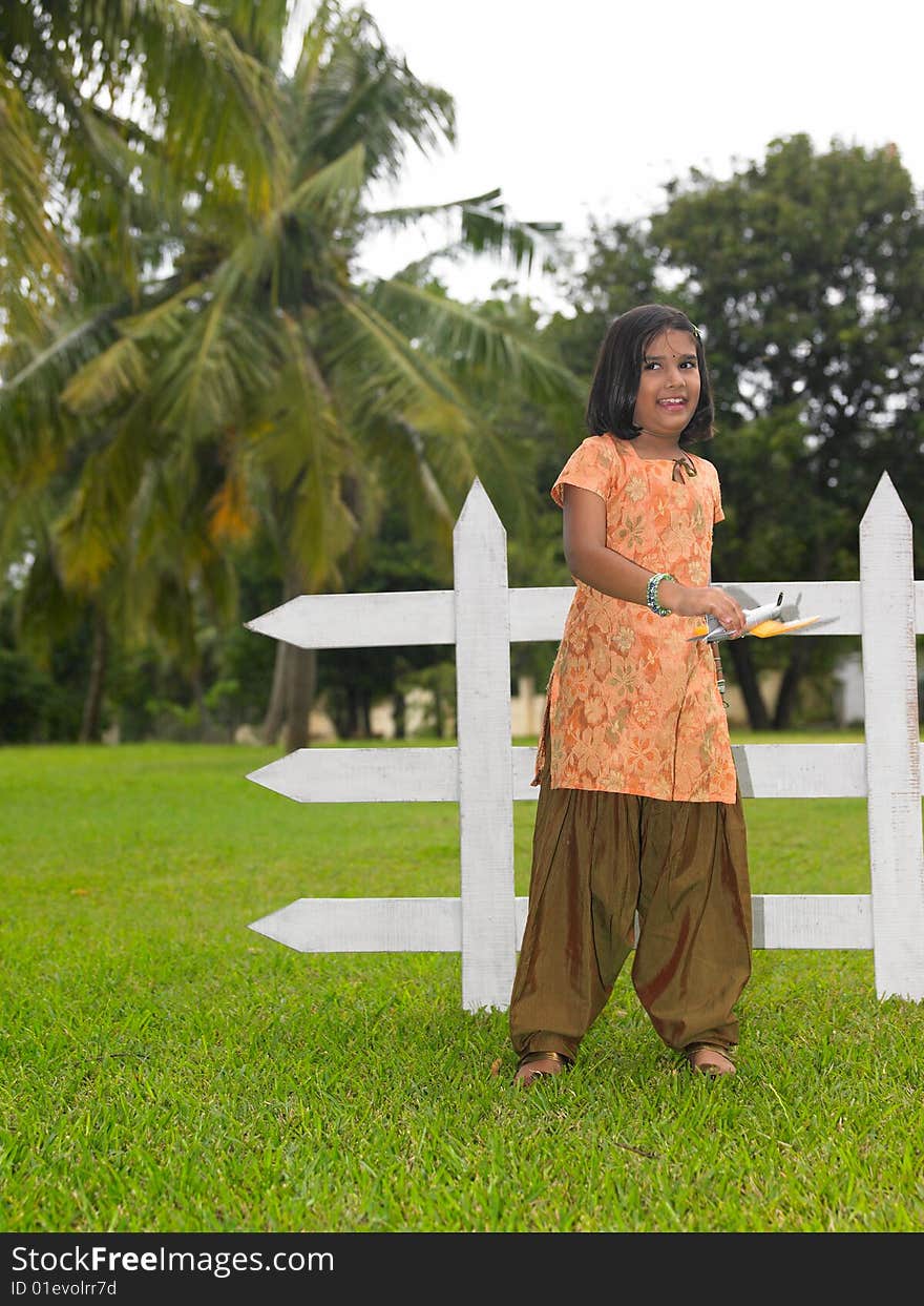 Asian kid in the park with her toy aeroplane