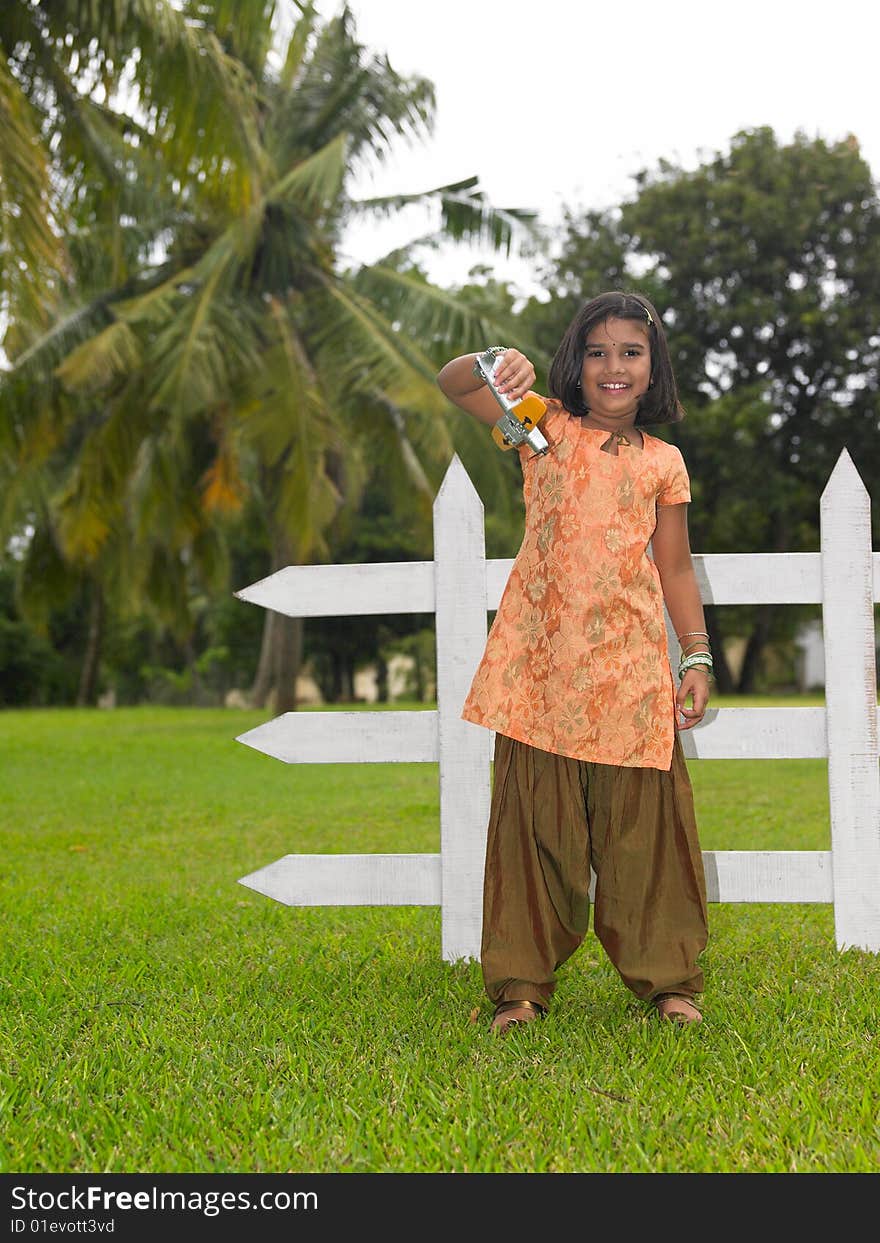 Asian kid in the park with her toy aeroplane