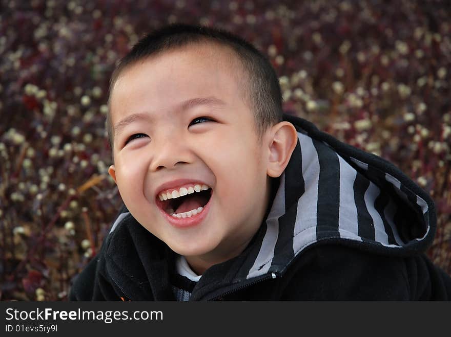 Young boy playing cheerfully in the garden